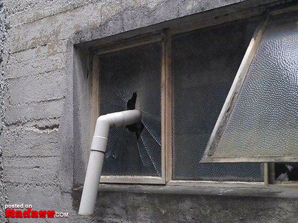 A broken window with a pipe sticking out of it, showcasing 50 Redneck Remedies to help you in times of need.