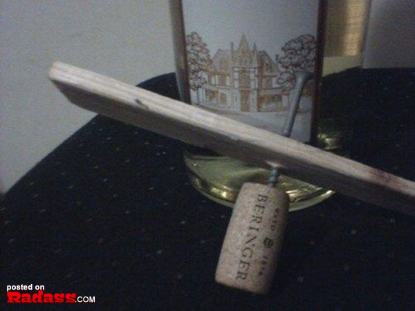 A bottle of wine with a wooden corkscrew next to it, accompanied by 50 Redneck Remedies.
