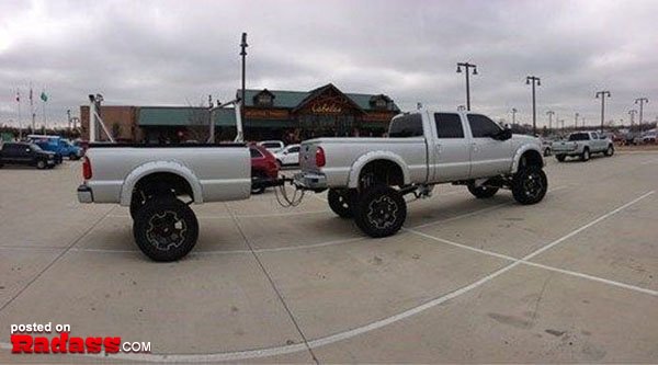 A white truck is parked in a parking lot.