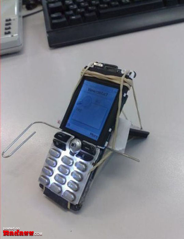 A cell phone is sitting alongside a keyboard.