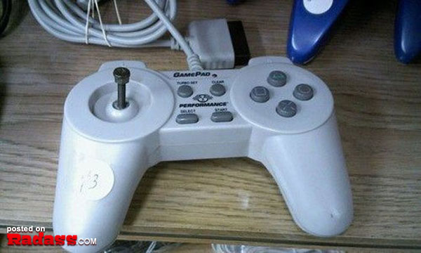 A white Nintendo game controller sitting on a table.