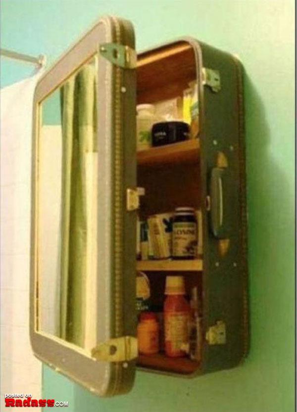 A bathroom with a quirky touch - a suitcase hanging on the wall, filled with 50 Redneck Remedies to help you in times of need.