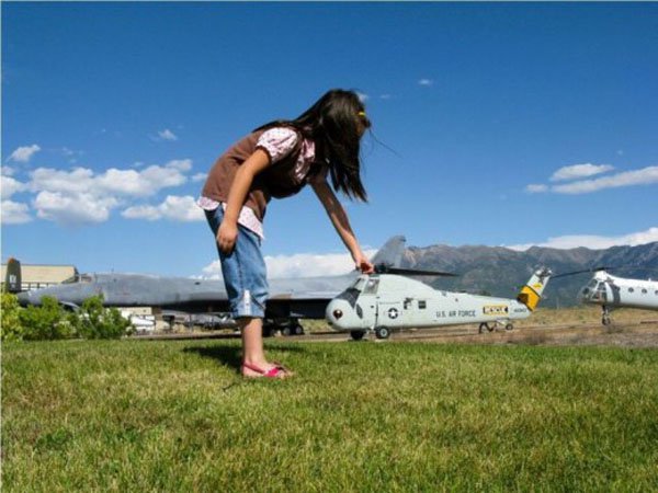 A girl admiring a model helicopter.
