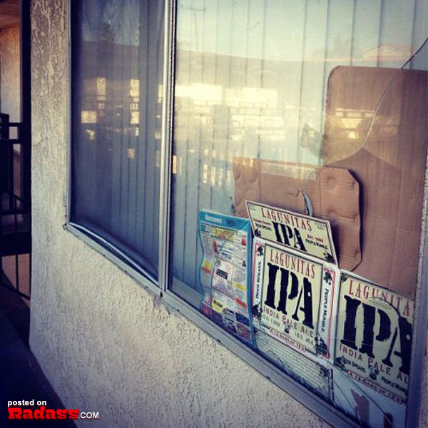 A newspaper is sitting in the window of a building.