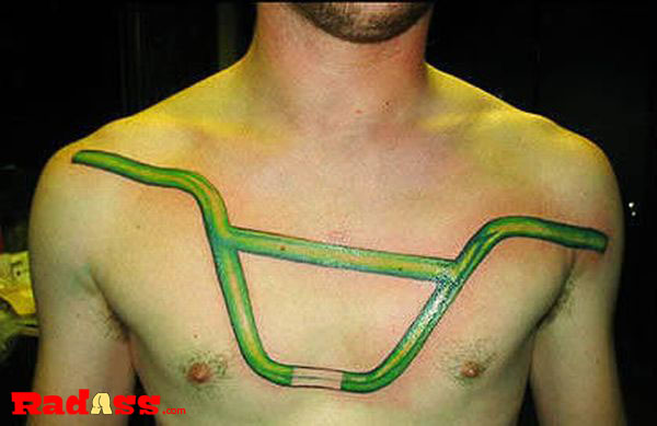 A man with a unique green bike handlebar tattoo on his chest, living in the moment and showcasing tats you would never get but love to see.