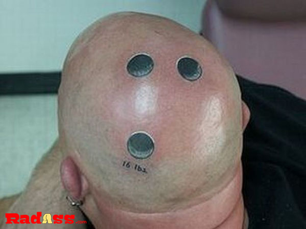 A tattooed man embracing the present moment with a unique head design.