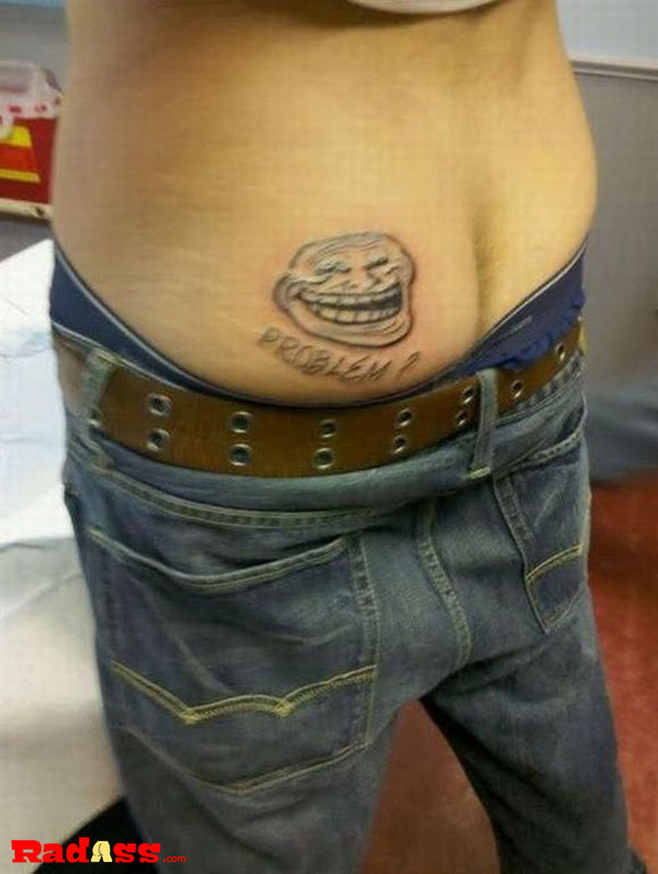 A man proudly displays a troll tattoo, reflecting his love for unconventional body art.