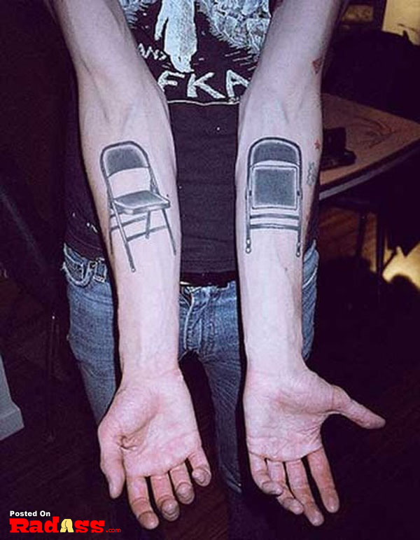 A man with permanent chair tattoos on his forearms.