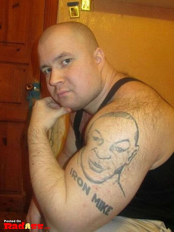 A bald man with a permanent tattoo on his arm.