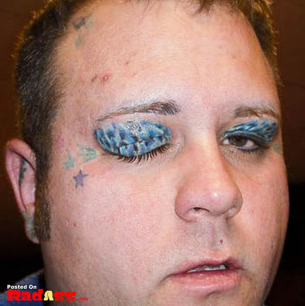A man with bold blue eye makeup showcasing his creativity.