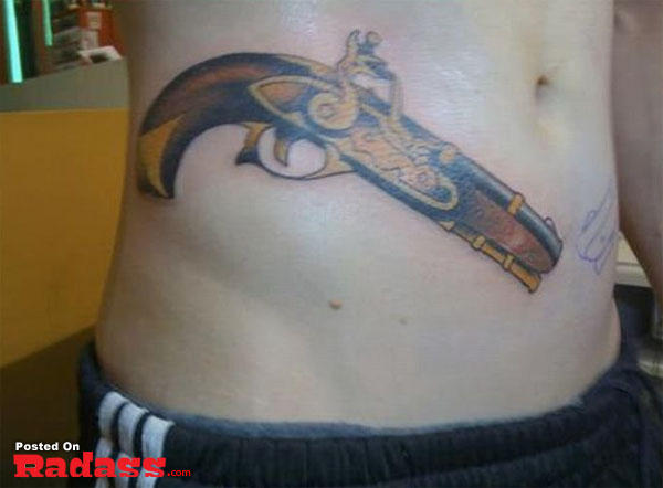 A man with a gun tattoo on his stomach, packing for life.