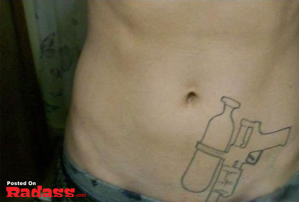 A woman with a tattoo of a gun on her stomach, packing for life in the presence of 32 people.