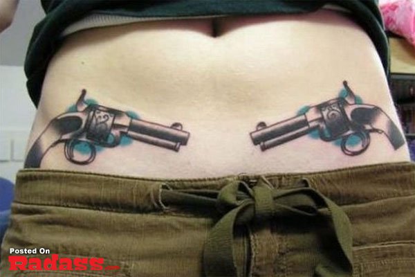 A woman with dual firearms tattooed on her stomach, showcasing her membership in the 32 People That Are Packing For Life.