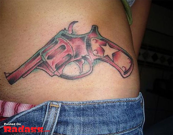 A woman's stomach tattoo featuring a revolver.