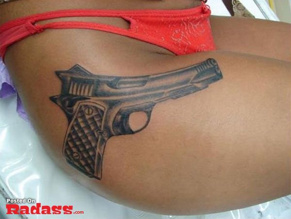 A woman with a gun tattoo on her thigh lives by the motto "32 People That Are Packing For Life.
