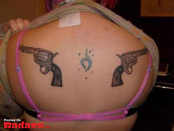 A woman packing a gun tattoo on her back.