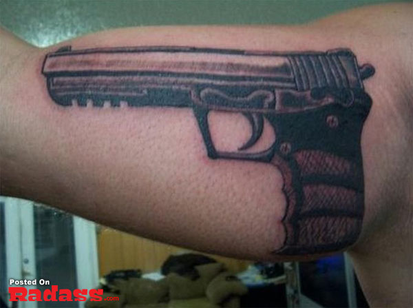 A man's arm sporting a gun tattoo among the 32 people that are packing for life.