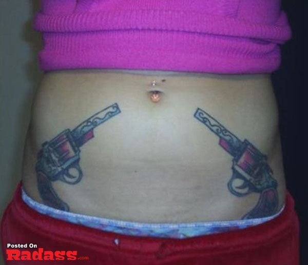 A woman packing a gun tattoo on her stomach.