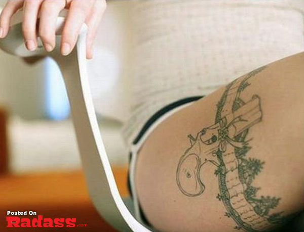 A woman with a tattoo on her thigh.