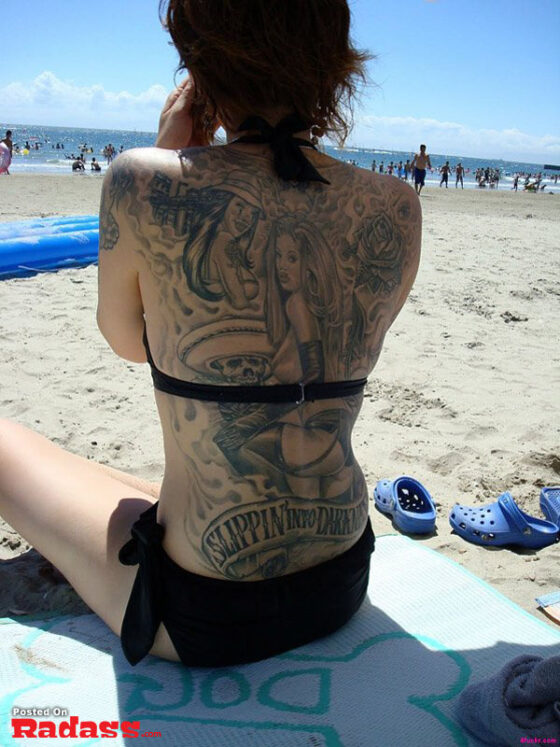 A hot girl with tattoos on her back.