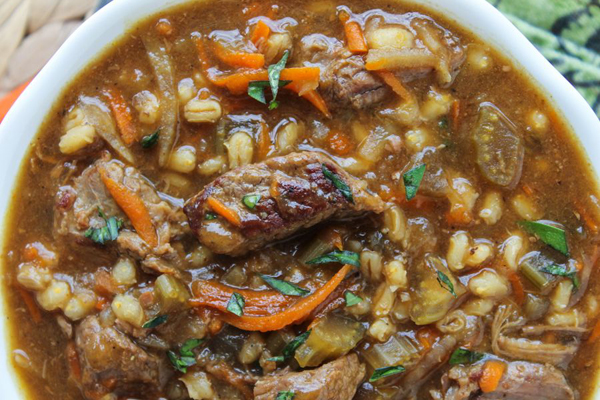 A comforting bowl of beef stew with carrots and onions.