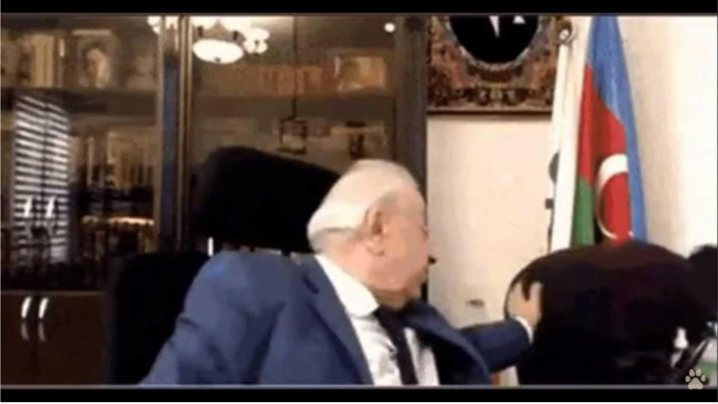 A man in a suit sitting in front of a flag explores the emergence and popularity of Lo-Fi music.