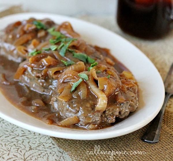 A comforting plate of meatloaf with onions and a warm cup of coffee.
