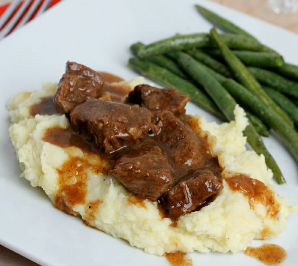 Comfort food: Beef and mashed potatoes with gravy on a white plate.