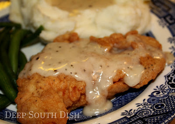Comfort food: Fried chicken with gravy and mashed potatoes on a blue and white plate.