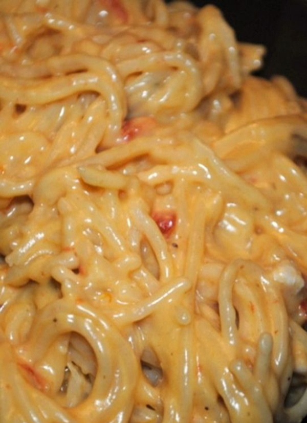 A comforting close up of cheesy pasta in a skillet.