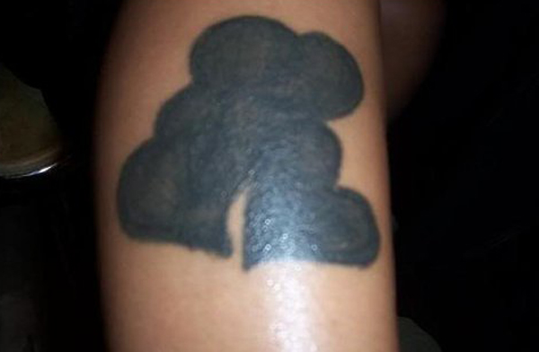 What a permanent black tattoo on a person's leg looks like.
