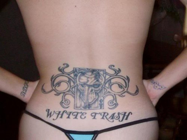 A woman with a white trash tattoo on her back, showcasing what a bad decision looks like forever in a bikini.