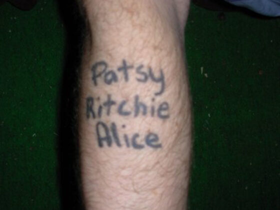 A man with a permanent tattoo that says patty kitty alice.