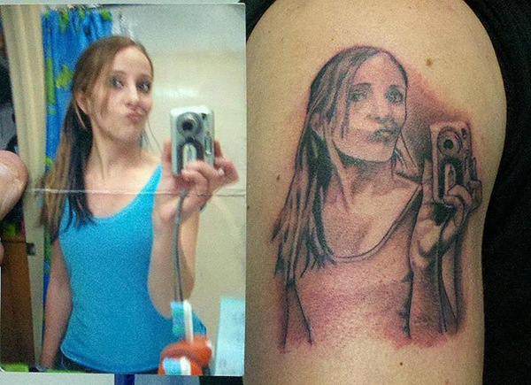 A regrettable tattoo of a girl holding a cell phone.