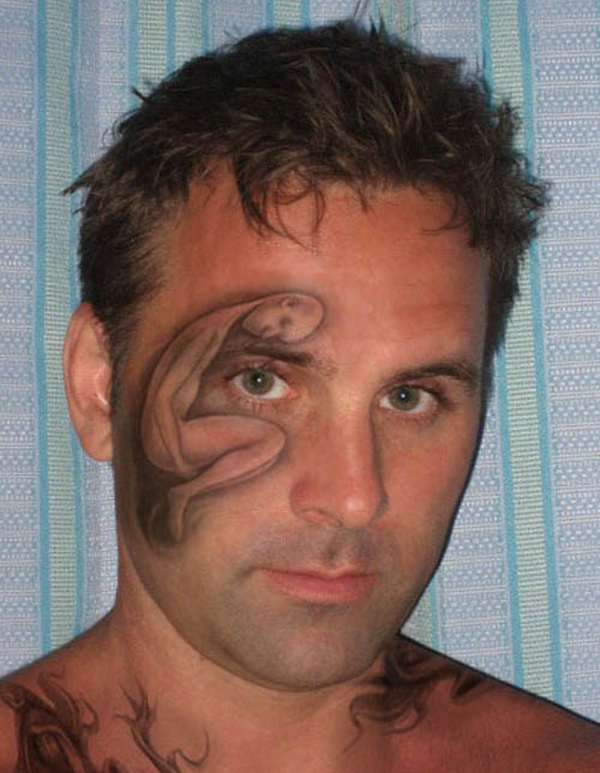 A man showcasing a tattoo that embodies a lifelong reminder of a regrettable choice.