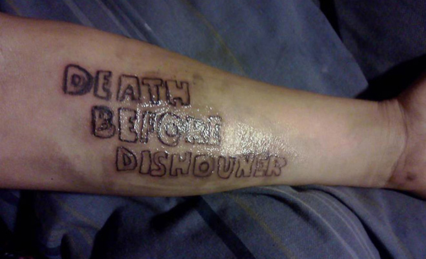 A permanent tattoo showcasing the phrase 'death before dishonor' exemplifies a lifelong commitment to loyalty.