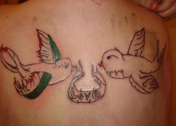 A woman with a regrettable tattoo of two birds on her back.
