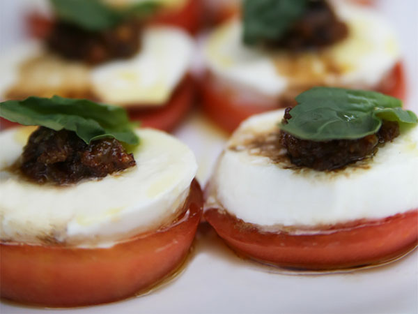 Stuffed tomatoes with goat cheese and basil on a white plate - Warning: Food Porn.