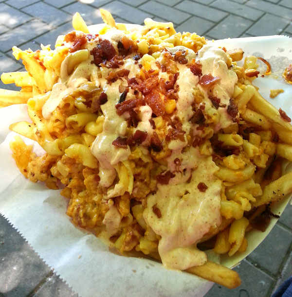 A person is indulging in a bowl of tantalizing french fries.