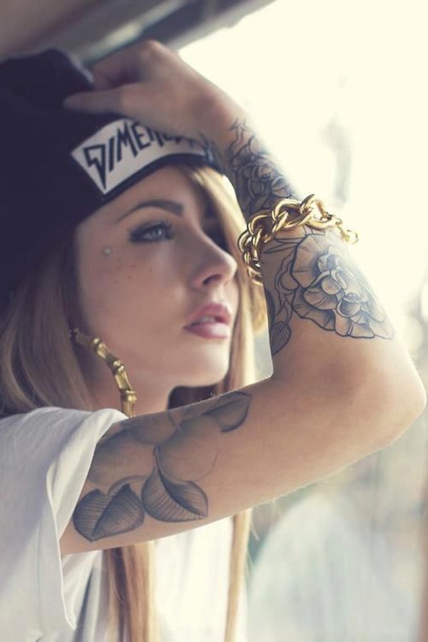 A woman wearing a hat with tattoos, showcasing hot girls and their tattoos in 39 pictures.