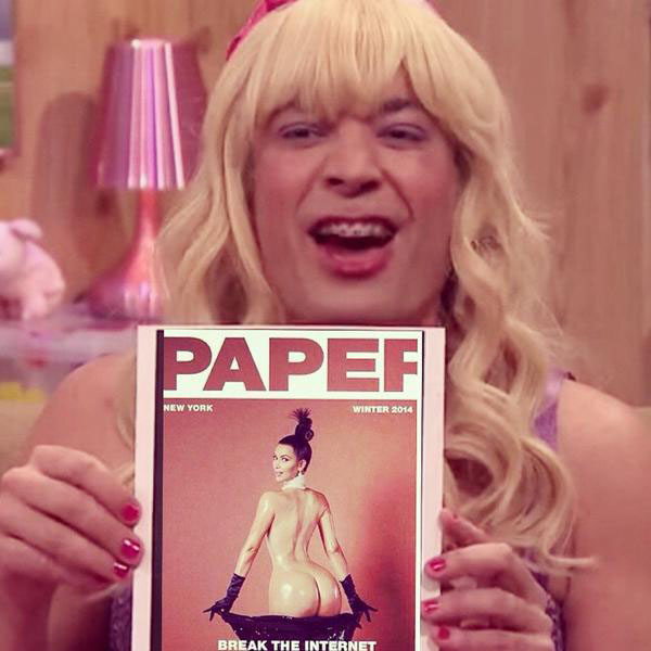 A woman holding up a paper magazine that catches the internet's attention.