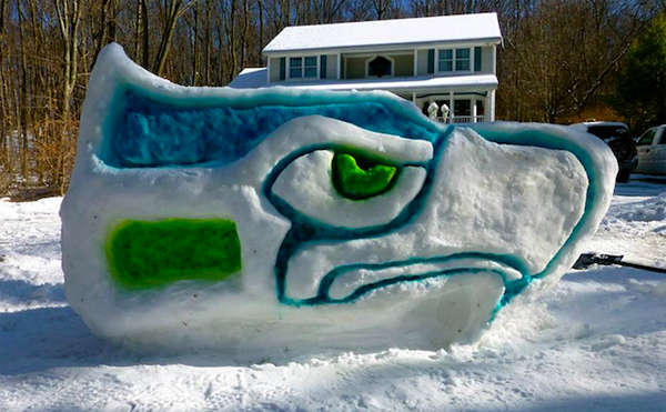 A snow sculpture of a Seattle Seahawks helmet brings winter joy.