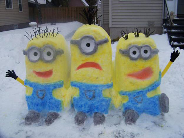 Three minion snow sculptures add a playful touch to the snowy landscape.