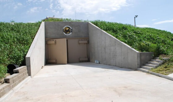 A luxury survival bunker with a door leading to a grassy area.