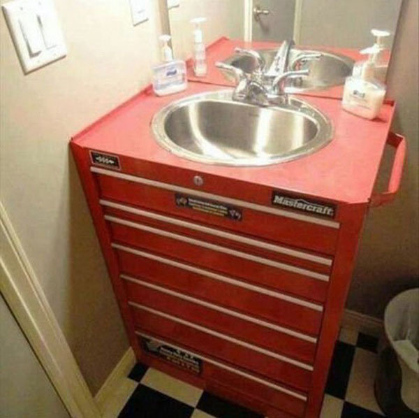 A bathroom with a red sink and optional tool drawers.