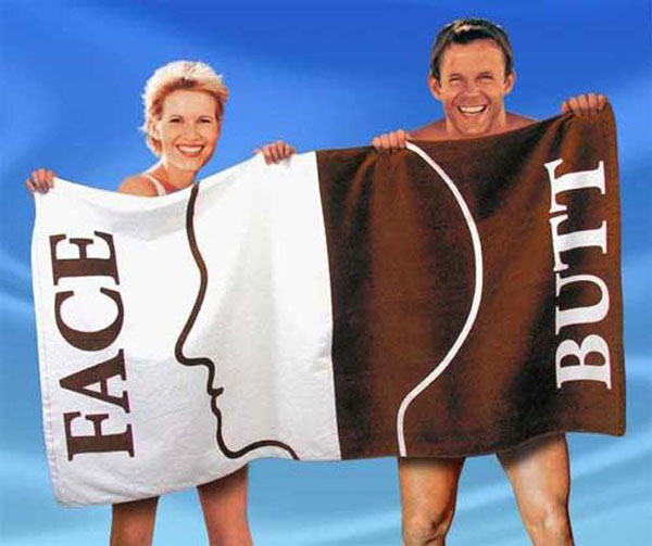 A couple grasping a towel that amusingly reads 