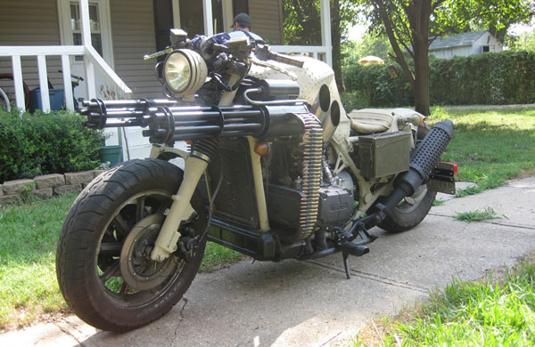 A motorcycle parked in front of a house displaying the owner's wants.