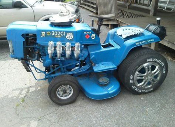 A blue tractor with a big engine parked by the road, tempting me to buy it despite being a want rather than a need.
