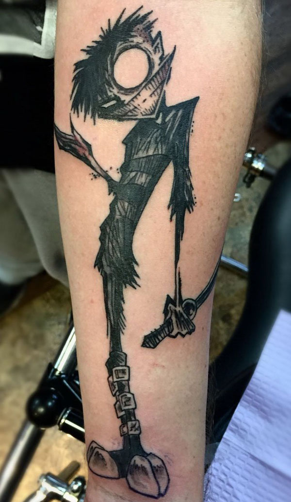 An unconventional tattoo featuring a cartoon character gripping a book.