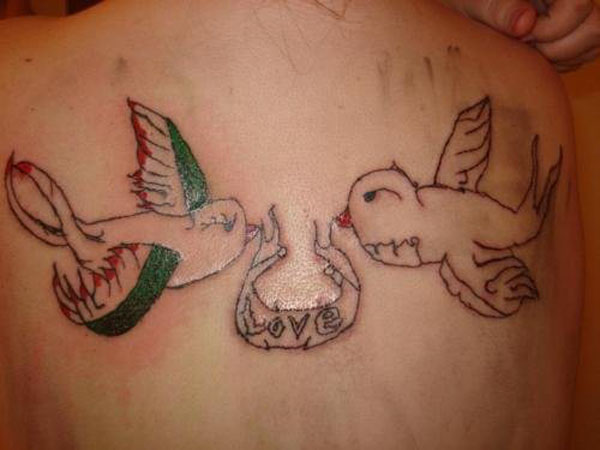 A woman displaying two birds tattooed on her back, offering a source of solace and empowerment.